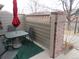 Private patio with outdoor dining set, brick privacy wall, and relaxed seating area at 559 Alton Way # C, Denver, CO 80230