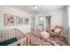 A cozy Bedroom featuring a crib, rocking chair, and colorful decor at 13029 E 103Rd Pl, Commerce City, CO 80022