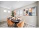 A dining room with contemporary artwork and a view from the large window at 13029 E 103Rd Pl, Commerce City, CO 80022