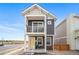 Charming two-story home with a balcony and a welcoming yellow front door at 13029 E 103Rd Pl, Commerce City, CO 80022