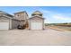 Detached garage with a wide driveway, providing ample parking space at 13029 E 103Rd Pl, Commerce City, CO 80022