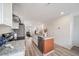 Bright, open kitchen with stainless steel appliances, granite countertops, and seamless flow to living area at 13029 E 103Rd Pl, Commerce City, CO 80022