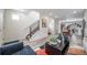 Open-concept living area showcases stylish decor, staircase access, and seamless flow to the kitchen at 13029 E 103Rd Pl, Commerce City, CO 80022