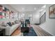 Cozy living room with a modern aesthetic, comfortable seating, and staircase access at 13029 E 103Rd Pl, Commerce City, CO 80022