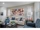 Stylish living room featuring modern artwork, contemporary furniture, and bright natural light at 13029 E 103Rd Pl, Commerce City, CO 80022