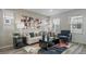 Bright living room featuring modern decor, plush seating, and large windows with natural light at 13029 E 103Rd Pl, Commerce City, CO 80022