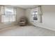 Comfortable bedroom featuring neutral tones and carpets, a single chair and bright windows at 9954 W Progress Pl, Littleton, CO 80123