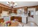 Functional kitchen featuring wood cabinets, modern appliances, and a convenient view into the adjacent living space at 9954 W Progress Pl, Littleton, CO 80123