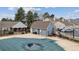 Community pool area showcases nearby townhomes, with seating and a covered pool at 9954 W Progress Pl, Littleton, CO 80123