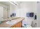 Well-lit bathroom features a vanity with a wide mirror and a shower with a glass door at 7440 S Blackhawk St # 14-208, Englewood, CO 80112