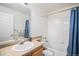 Clean bathroom with a vanity, toilet, and shower-tub with a stylish shower curtain at 7440 S Blackhawk St # 14-208, Englewood, CO 80112