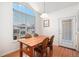 Cozy dining room with natural light, wood floors, and a view of the complex at 7440 S Blackhawk St # 14-208, Englewood, CO 80112
