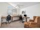 Home office with built-in desk, comfortable seating, a ceiling fan, and natural light at 7440 S Blackhawk St # 14-208, Englewood, CO 80112