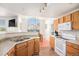 Bright kitchen with ample cabinets and appliances with view to the dining area at 7440 S Blackhawk St # 14-208, Englewood, CO 80112