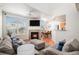 Bright living room with fireplace, large windows, and open access to dining area and kitchen at 7440 S Blackhawk St # 14-208, Englewood, CO 80112