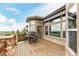 A view of a back deck with awning, outdoor seating and stone railings, offering scenic views at 12467 Topaz Vista Way, Castle Pines, CO 80108