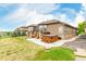 A large backyard featuring a patio, hot tub, grassy area, and mature trees at 12467 Topaz Vista Way, Castle Pines, CO 80108