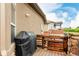 An exterior view of backyard featuring a built-in grill, wood fence, and stone accents at 12467 Topaz Vista Way, Castle Pines, CO 80108