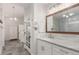 Bright bathroom features marble countertop, framed mirror and access to the shower and linen closet at 12467 Topaz Vista Way, Castle Pines, CO 80108