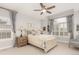 Bright primary bedroom with a decorative ceiling fan and large shuttered windows at 12467 Topaz Vista Way, Castle Pines, CO 80108