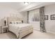 A cozy bedroom featuring neutral walls, plush carpeting, stylish furnishings, and a window for natural light at 12467 Topaz Vista Way, Castle Pines, CO 80108