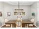 Dining area featuring a hardwood table, stylish chairs, and a decorative light fixture at 12467 Topaz Vista Way, Castle Pines, CO 80108