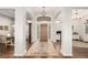 Inviting foyer boasts gleaming floors, an elegant light fixture, and natural light at 12467 Topaz Vista Way, Castle Pines, CO 80108