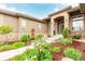 Charming entrance adorned with stone accents, decorative plants and mulch, and a pathway at 12467 Topaz Vista Way, Castle Pines, CO 80108