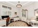 Home office featuring custom built ins, hardwood floors, a patterned rug, recessed lighting and many windows at 12467 Topaz Vista Way, Castle Pines, CO 80108