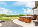 A backyard hot tub with stone accents, wood fencing and lush greenery, perfect for relaxation at 12467 Topaz Vista Way, Castle Pines, CO 80108