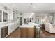 Open concept kitchen featuring a large island with bar seating, stainless steel appliances, and hardwood flooring at 12467 Topaz Vista Way, Castle Pines, CO 80108