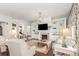 Open-concept living area with a fireplace, built-in shelving, and stylish furnishings at 12467 Topaz Vista Way, Castle Pines, CO 80108