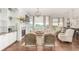 Elegant living area with fireplace, built-in shelving, hardwood floors, and plentiful natural light at 12467 Topaz Vista Way, Castle Pines, CO 80108