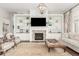 Elegant living space featuring a fireplace, extensive built-ins, and an open layout at 12467 Topaz Vista Way, Castle Pines, CO 80108