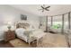 Serene main bedroom with a ceiling fan, windows, and lots of natural light with an ensuite bathroom at 12467 Topaz Vista Way, Castle Pines, CO 80108
