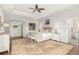 Spacious main bedroom features a tray ceiling, ceiling fan, ensuite bathroom, and seating area at 12467 Topaz Vista Way, Castle Pines, CO 80108
