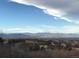 Scenic view of the community with mountains in the distance under a blue sky at 12467 Topaz Vista Way, Castle Pines, CO 80108