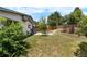 Expansive backyard with patio and mature trees, providing ample space for outdoor activities and relaxation at 1430 Mount Evans Dr, Longmont, CO 80504