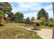 Backyard with patio and dining set surrounded by greenery, creating a serene and inviting outdoor space at 1430 Mount Evans Dr, Longmont, CO 80504