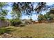 Spacious backyard with a patio and mature trees, creating a peaceful and private outdoor environment at 1430 Mount Evans Dr, Longmont, CO 80504