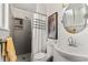 Modern bathroom with a tiled shower, updated fixtures, and a decorative mirror at 1430 Mount Evans Dr, Longmont, CO 80504