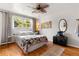 Serene bedroom with hardwood floors, large window, and stylish decor at 1430 Mount Evans Dr, Longmont, CO 80504