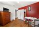 Cozy bedroom features hardwood floors, closet, and complementary red accent wall at 1430 Mount Evans Dr, Longmont, CO 80504