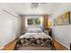 Comfortable bedroom featuring hardwood floors, a large window, and ample closet space at 1430 Mount Evans Dr, Longmont, CO 80504