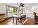 Light-filled dining room with hardwood floors and a view of the outdoor greenery from a large window at 1430 Mount Evans Dr, Longmont, CO 80504