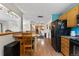 Open-concept kitchen and dining area with hardwood floors and updated appliances at 1430 Mount Evans Dr, Longmont, CO 80504