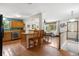 Open kitchen and dining area featuring hardwood floors, breakfast bar, and ample counter space at 1430 Mount Evans Dr, Longmont, CO 80504