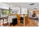 Open layout kitchen with wood floors, breakfast bar, and seamless access to the dining area at 1430 Mount Evans Dr, Longmont, CO 80504
