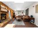 Inviting living room with a cozy brick fireplace, a skylight, and comfortable seating at 1430 Mount Evans Dr, Longmont, CO 80504