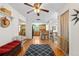 Bright living room featuring hardwood floors, a ceiling fan, and views into the kitchen at 1430 Mount Evans Dr, Longmont, CO 80504